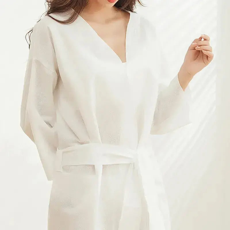 Premium disposable nonwoven robes for luxury hotels and spas, opaque and breathable, manufactured by Little Cotton B2B facility.