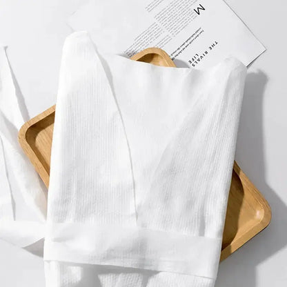 Premium disposable nonwoven robes for luxury hotels and spas, opaque and breathable, manufactured by Little Cotton B2B facility.