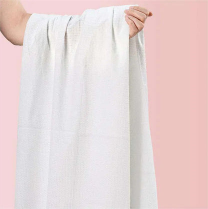 Premium 70x140cm disposable pure cotton bath towels for luxury hotels and spas, bulk produced by Little Cotton OEM facility.